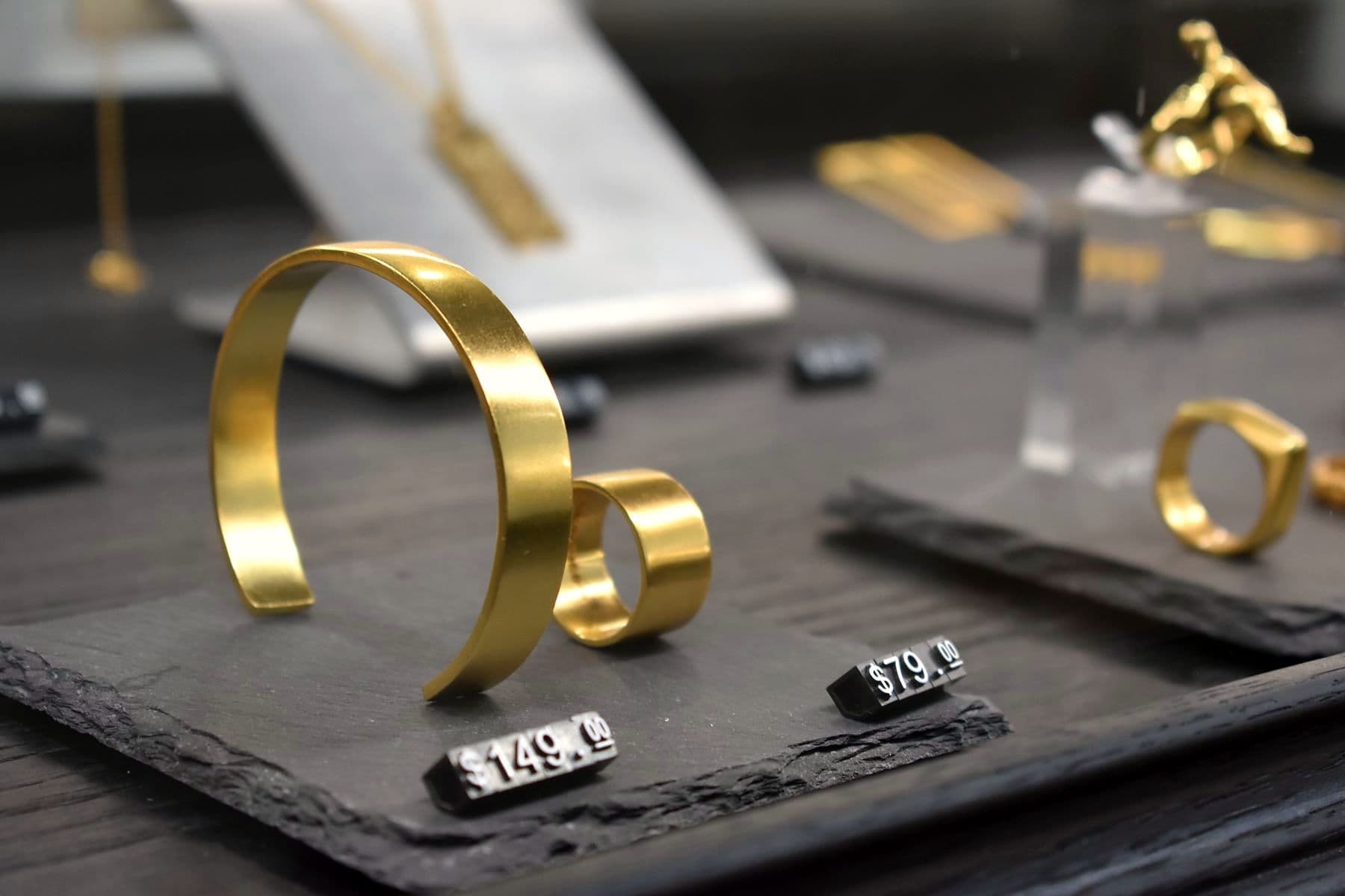 Gold cuffs and rings in a display case